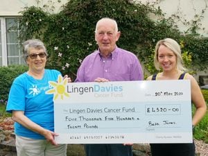 Doreen Owen volunteer with Lingen Davies accepts the cheque from Alun Jones and his granddaughter Beth. 