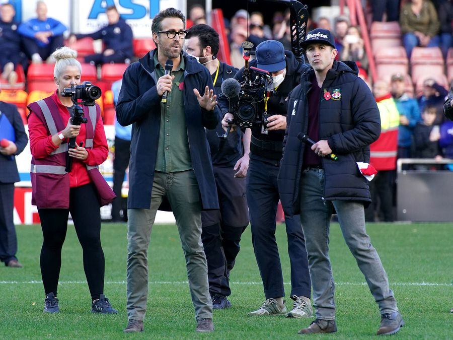 Wrexham owners Ryan Reynolds (left) and Rob McElhenney speak to the crowd before a Vanarama National League match at the Racecourse Ground last year. Photo: Peter Byrne/PA Wire