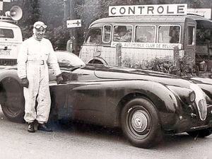 Norman Dewis in Belgium in 1953, by the Jaguar SK120 he drove at a record 172.4 mph