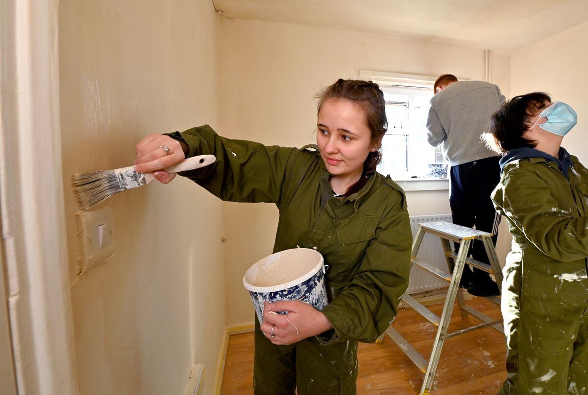 Student Amber Bolton hard at work sprucing up the home