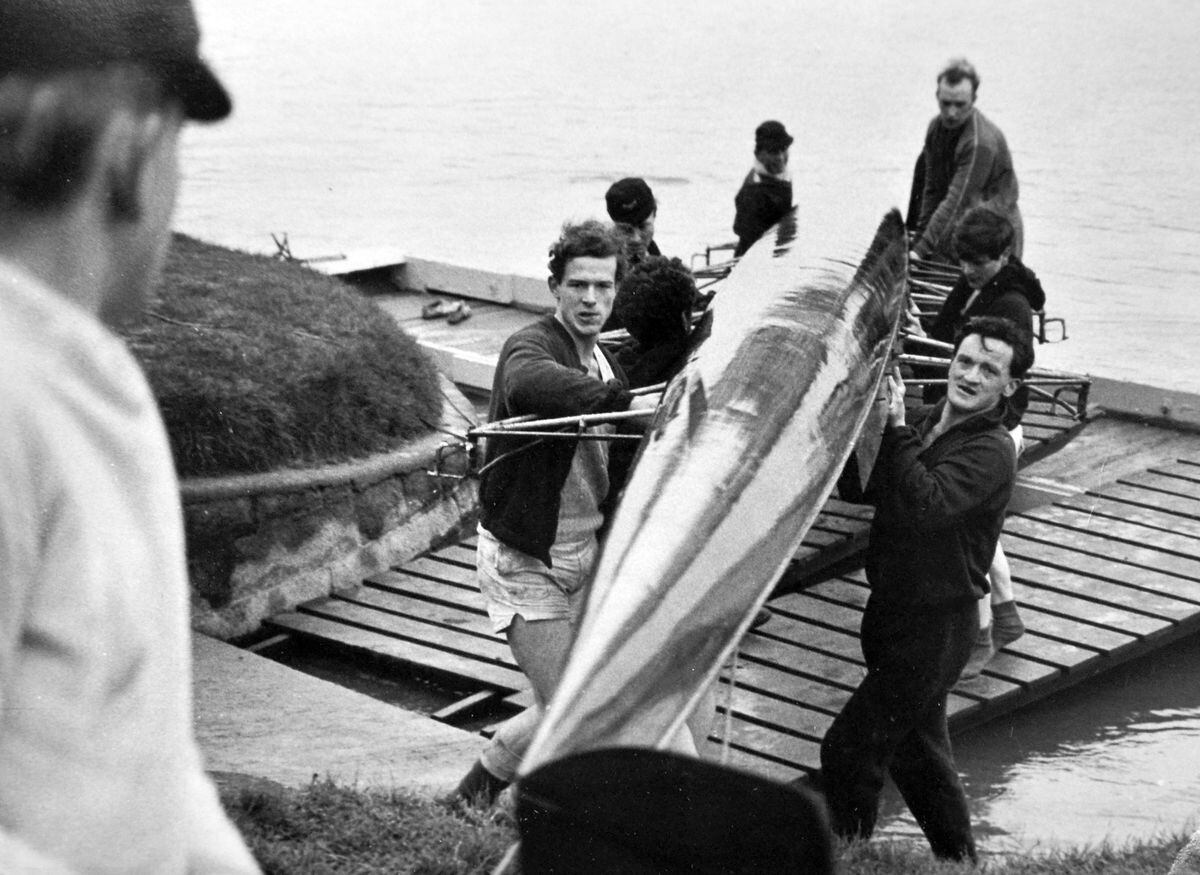 Row, row, row your boat... The crew of the host club, Pengwern, haul their boat ashore at the end of a Head of the River race held on the River Severn at Shrewsbury on April 2, 1966.