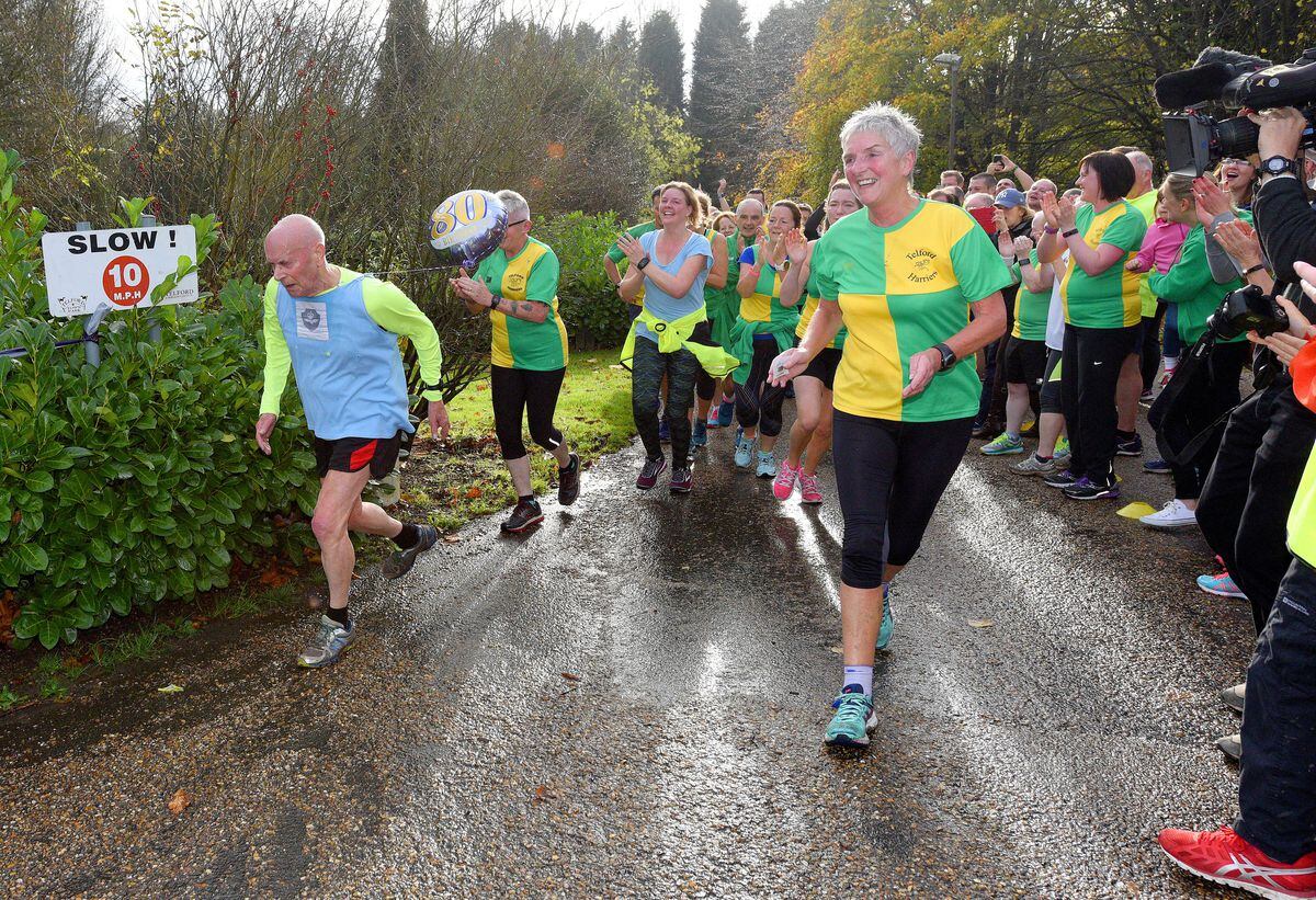Jim Hussey celebrates his 80th birthday during the Telford Park run