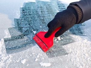 Scraping ice from the car window