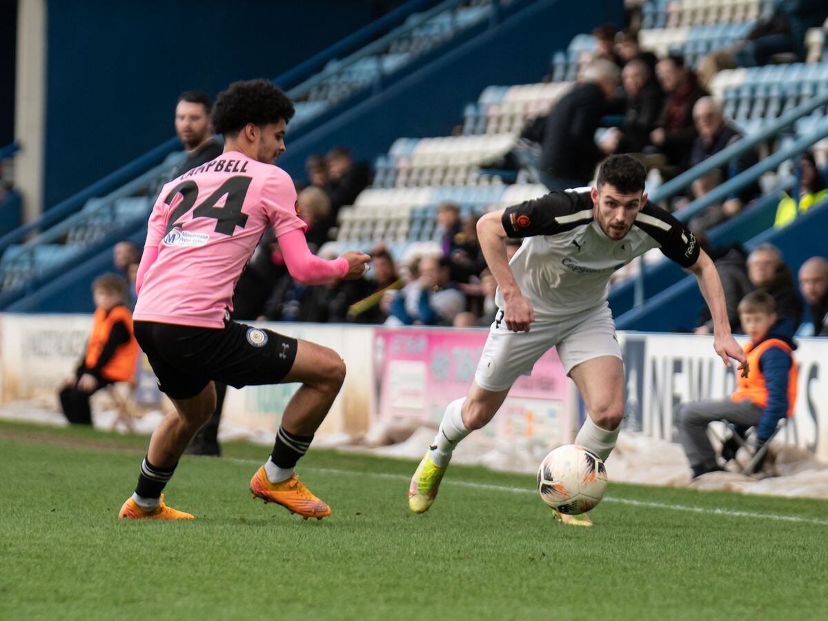 Adam Livingstone (25) (AFC Telford United Defender) brings the ball down the wing past Curzons Hayden Campbell