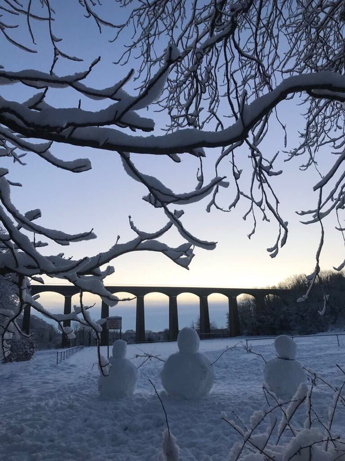 Snow in Llangollen as these cheeky snowmen watch the sun coming up.Picture: Johanna Cooke 