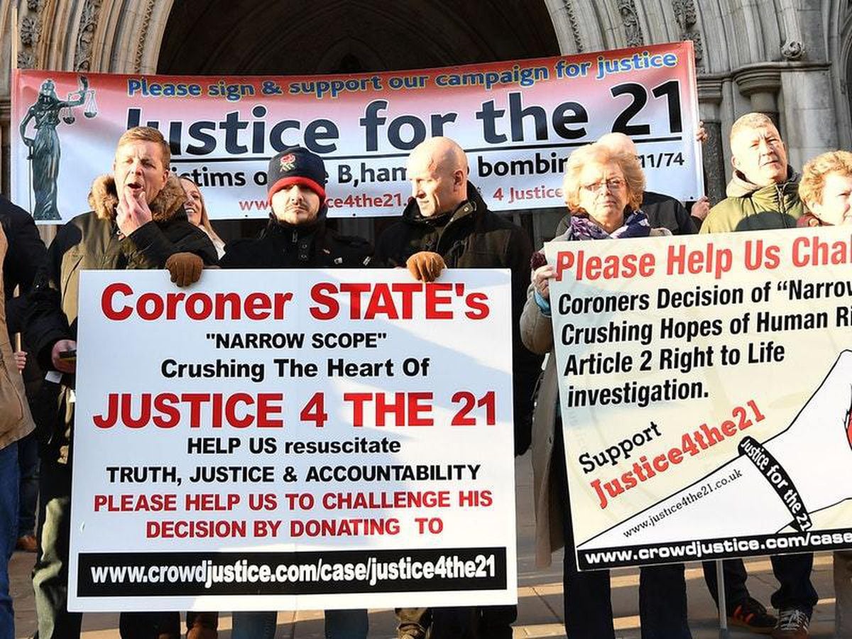 Protesters outside the High Court in London demanding justice for the 21 victims of the Birmingham pub bombings (John Stillwell/PA)