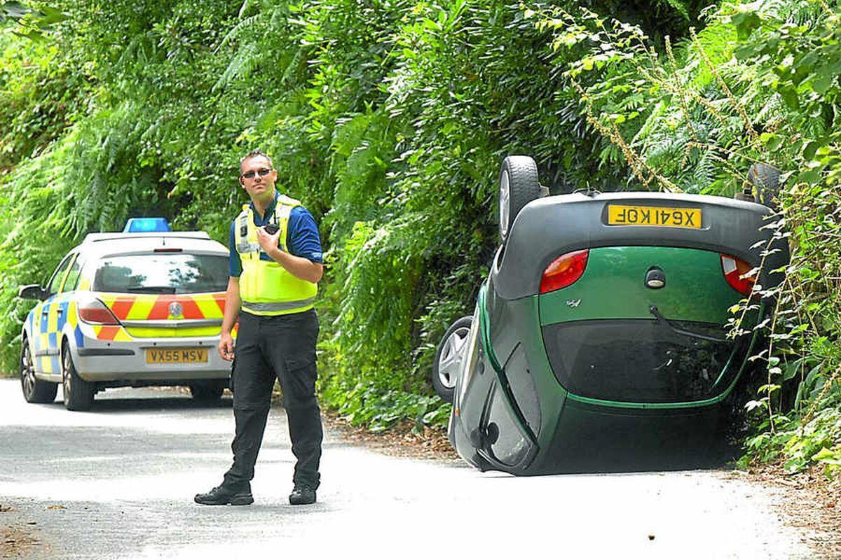 A woman driver was rescued when her car landed on its roof after it crashed down an embankment in Clive
