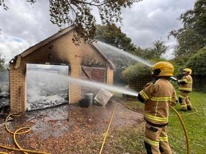 Firefighters fight the blaze at the garage at Chirk Bank