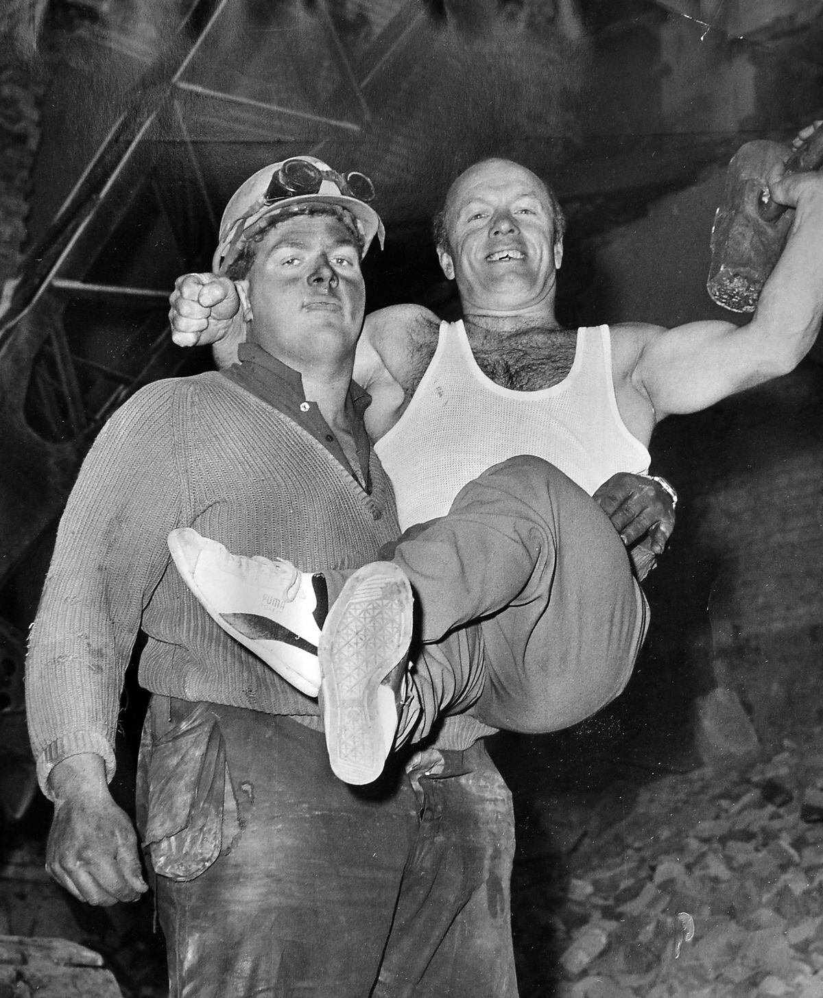 One of this pair is a circus strongman, but it's not the one you think. It's January 12, 1971, and Ivan Karle, at 4ft 10ins "the world's smallest strongman" and a member of Robert Brothers circus which was entertaining at the Granada at Shrewsbury at the time, had just lifted "Big Bob," a 21 stone, 6ft 6ins demolition worker at the old Shirehall demolition site, 18 inches off the ground and held him. Add the weight of Ivan's two stone lifting table, and the total was 23 stone, over twice the strongman's own weight. Afterwards Bob swept Ivan into the air to show his appreciation. 