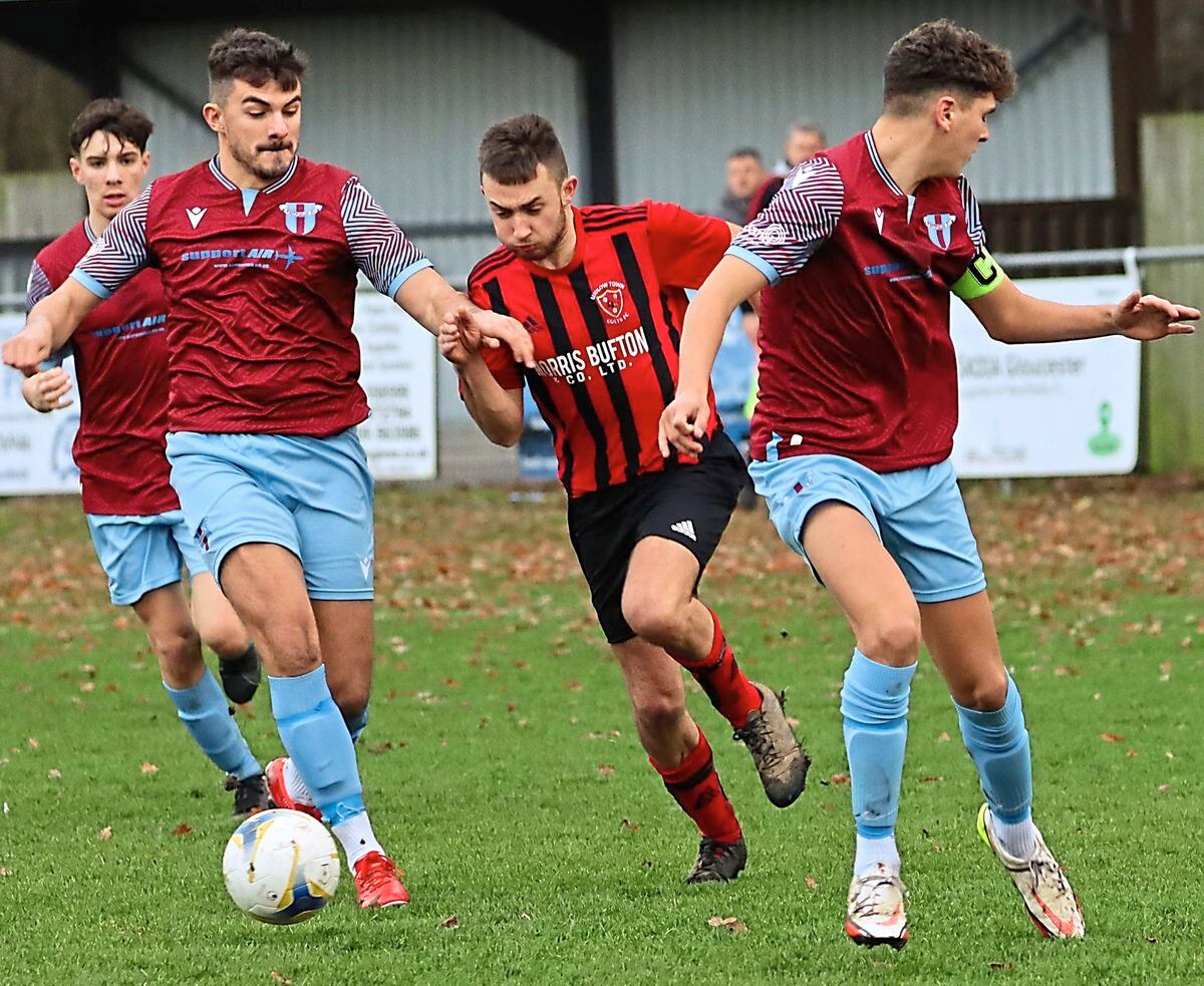 Ludlow Town Colts’ Kieron Hollis tries to squeeze his way between two Westfields players    Picture: Graham Gould