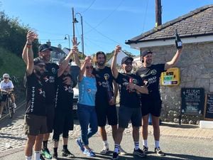The Unskateables celebrating their journey's end in Cemaes Bay. Photo: Bethan Scott