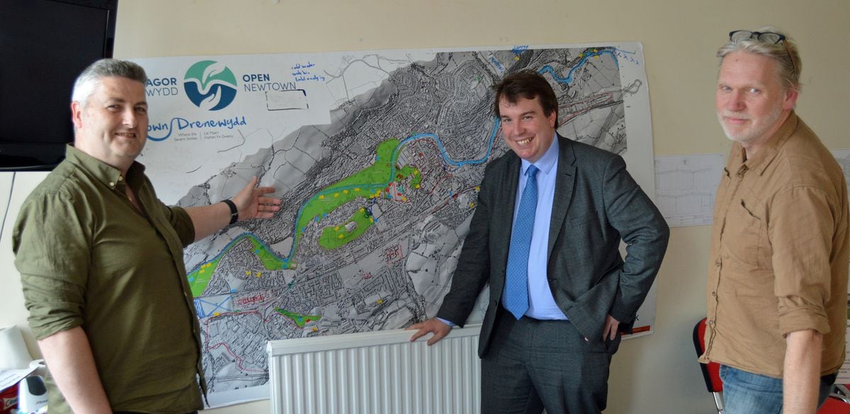 Montgomeryshire MP is shown a map of Newtown’s green spaces by Stuart Owen and Adam Kennerley from Open Newtown. 