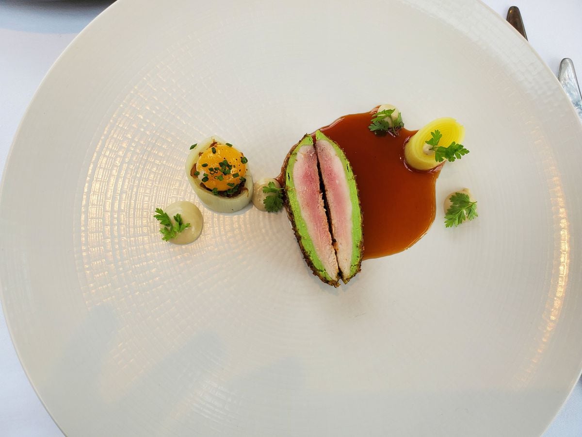 Quail starter with a herby crust and leek garnish 