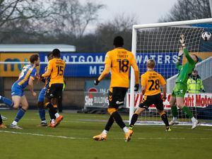 Matthew Pennington of Shrewsbury Town scores a goal to make it 0-3..