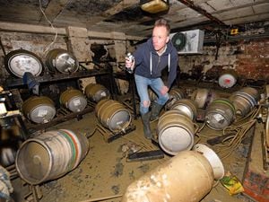 Ollie Parry, owner of The Salopian bar, Shrewsbury, surveys the cellar of the pub after the extensive recent flooding