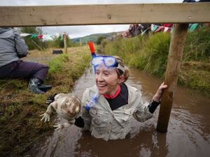 Competitors take part in the Rude Health World Bog Snorkelling Championships at Waen Rhydd peat bog in Llanwrtyd Wells, Wales. Picture date: Sunday August 27, 2023. PA Photo. Bog snorkelling is a sporting event where competitors aim to complete two consecutive lengths of a 60 yards water-filled trench cut through a peat bog in the shortest time possible, wearing traditional snorkel, diving mask and flippers. Photo credit should read: Ben Birchall/PA Wire.