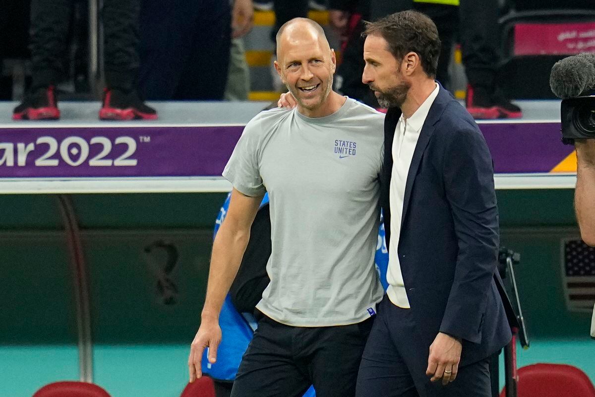 Head coach Gregg Berhalter of the United States and England's head coach Gareth Southgate talk at the end of the World Cup group B soccer match between England and The United States, at the Al Bayt Stadium in Al Khor , Qatar, Friday, Nov. 25, 2022. (AP Photo/Julio Cortez).