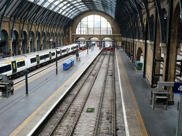 Empty platform and a stationary train at Kings Cross station in London