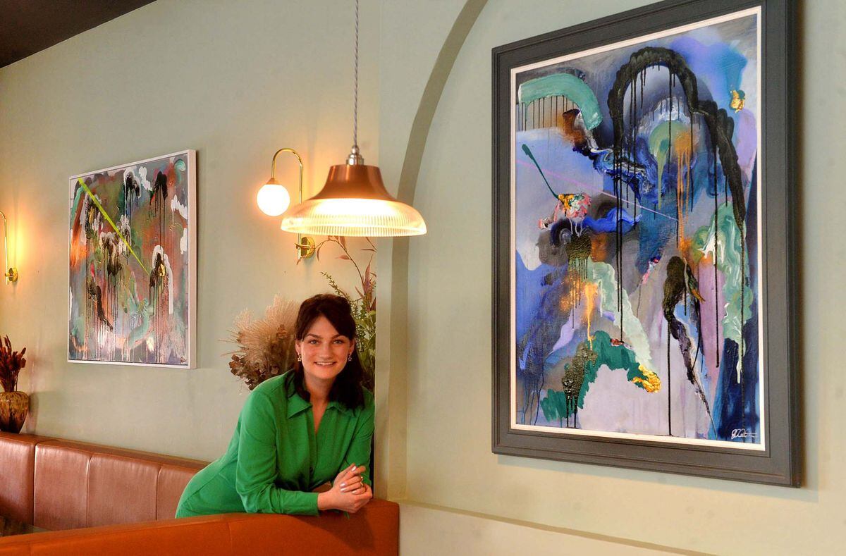 Georgina Walton with her exhibition at The Walrus