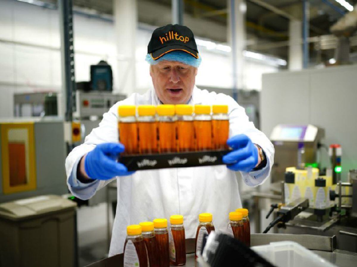 Boris Johnson during a visit to Hilltop Honey in Newtown, Powys, Wales. Photo: Ben Birchall/PA Wire