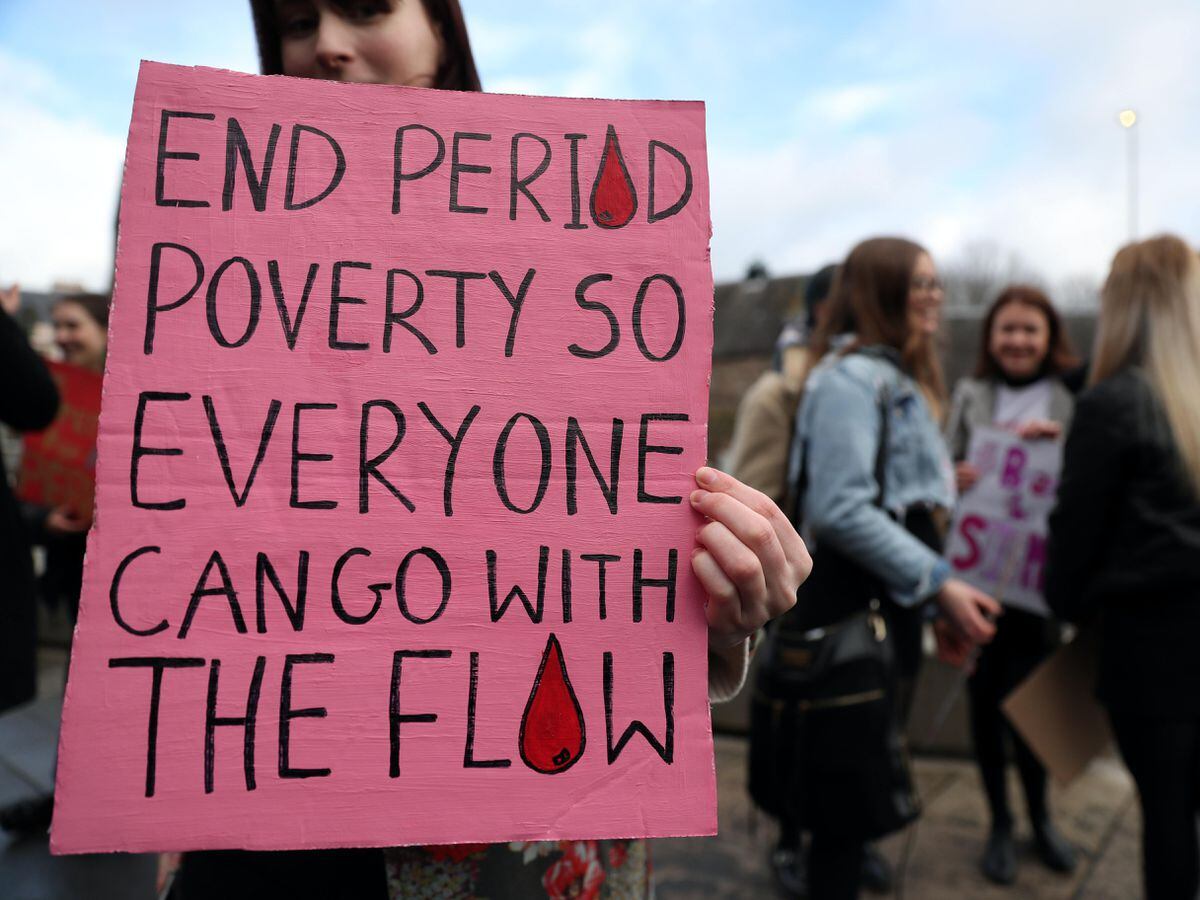 A sign calling for an end to period poverty