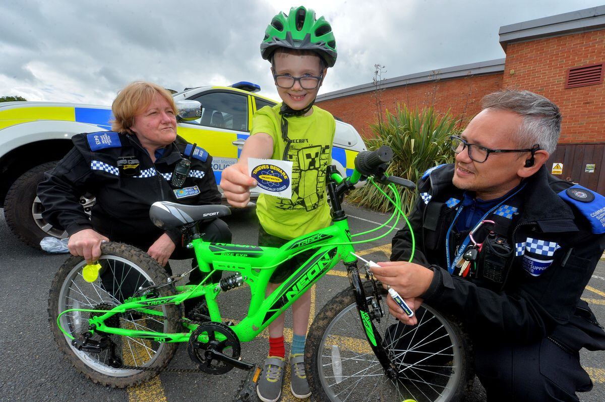 Police community support officers Shelley Hyde and Steve Breese helping Benedickt Michael Griffin mark his bike with Smartwater at Highley Community Day.