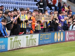 Shrewsbury Town fans hold up a sign saying, thank you Shaun Whalley.