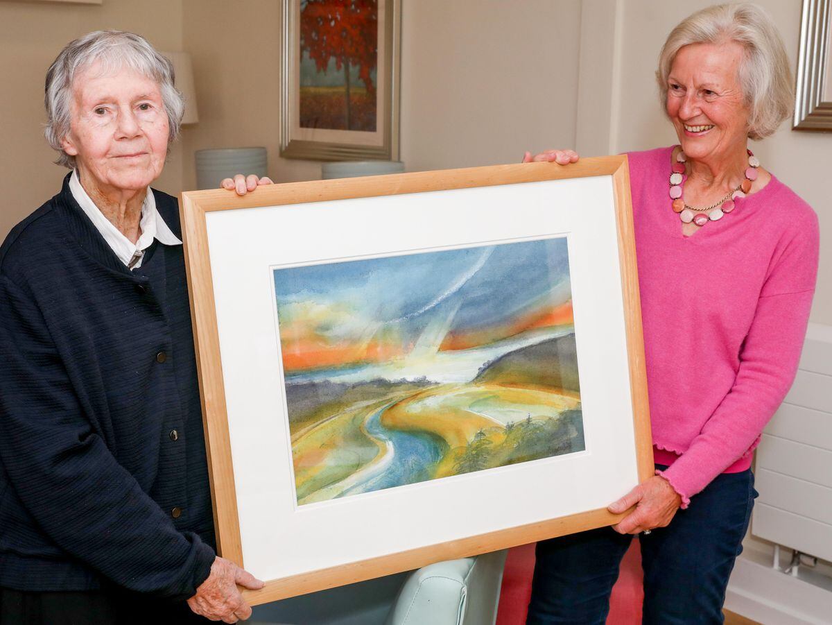 Jenny shows off one of Angela's paintings, 'Mawddach Estuary'.