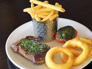 Raise the steaks – the sirloin steak with fries, onion rings and grilled tomatoPictures by Russell Davies