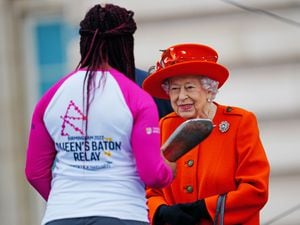 Parasport athlete Kadeena Cox receives the Baton from The Queen at the Queen’s Baton Relay launch
