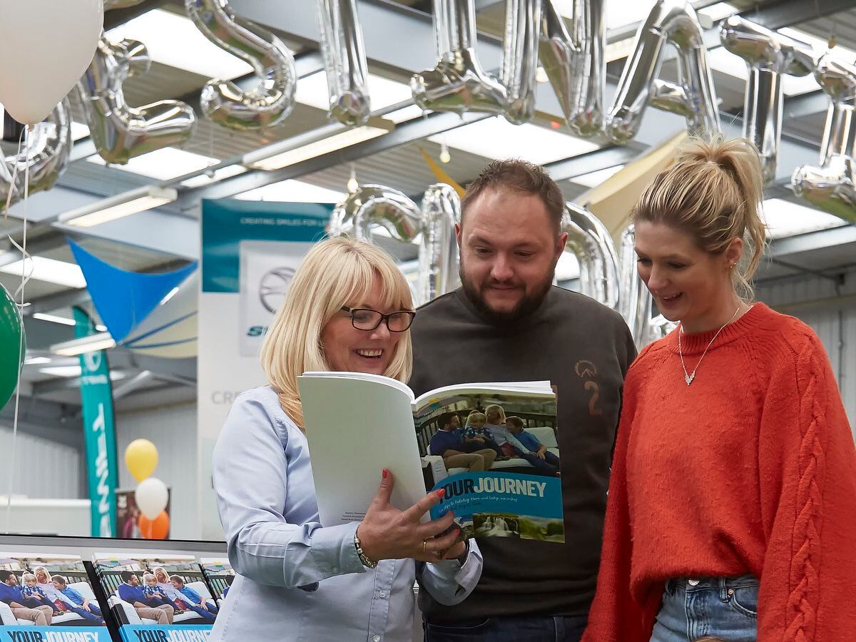 Salop Leisure’s holiday homes sales executive Tanya Richards with customers at a previous West Midlands Caravan & Motorhome New Model Show.