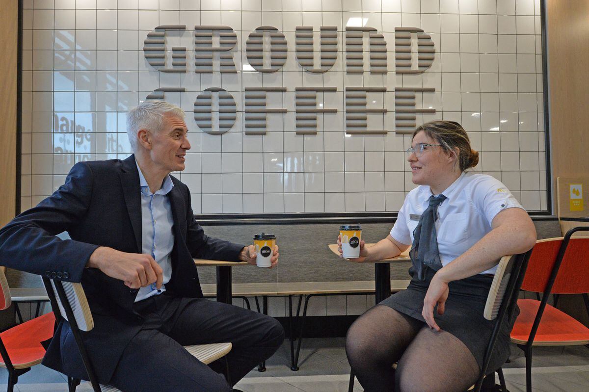 McDonald's franchisee Matthew Winfield with employee Niamh Carlin and the restaurant's ground coffee sign made from old coffee beans.