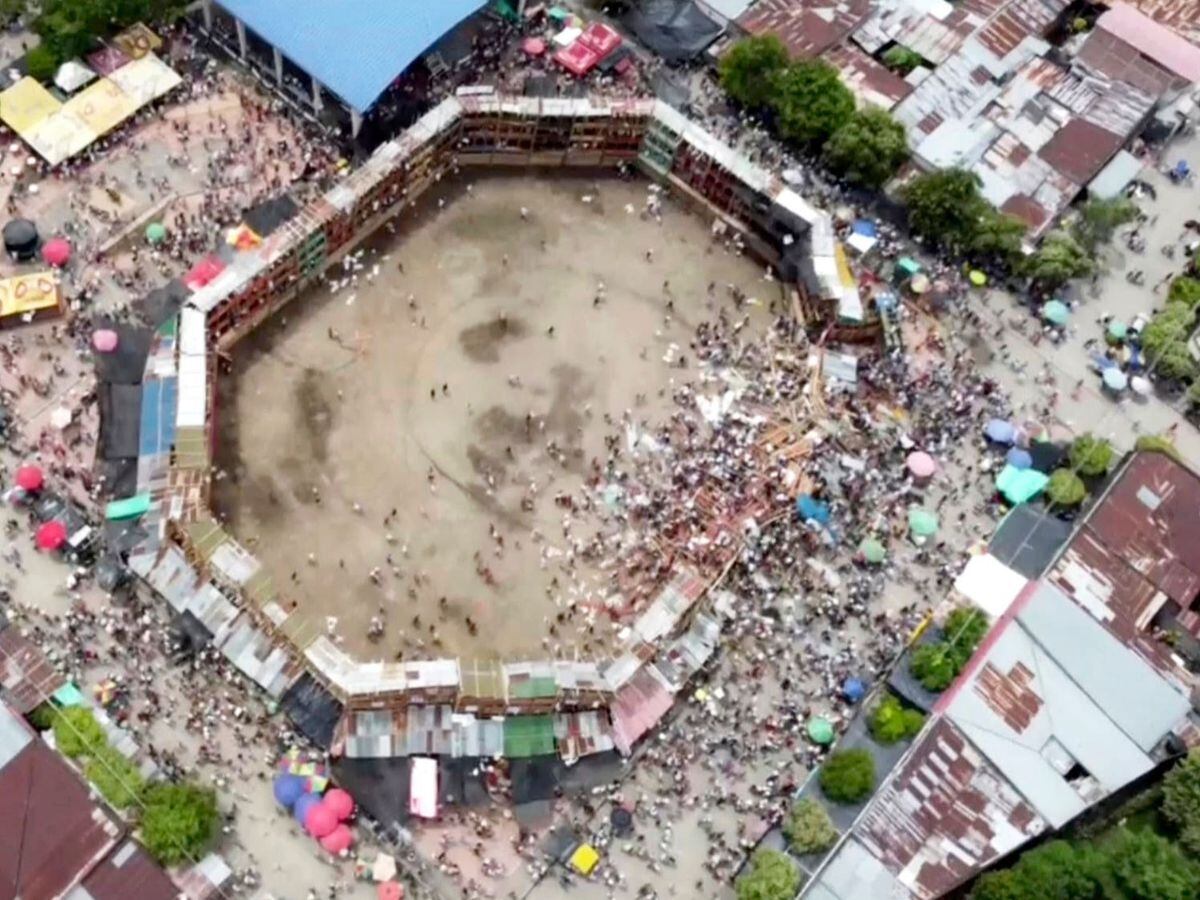 In this image taken from video, spectators are sent plunging to the ground as part of a wooden stand collapses during a bullfight