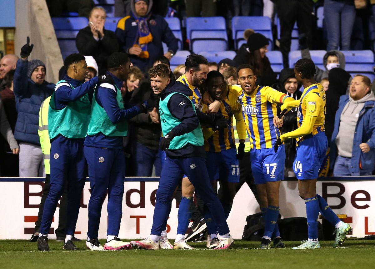 Daniel Udoh celebrates his dramatic late winner against Charlton with all his team-mates in front of the South Stand.