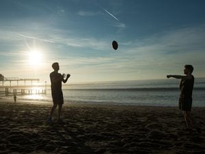 Two boys play with an American Football on Aberystwyth beach in Wales, as a new record has been set for the UK's warmest February day. The thermometer reached 20.3C (68.5F) at Trawsgoed in Ceredigion, west Wales, beating the previous record of 19.7C (67.4F) recorded in Greenwich in 1998. PRESS ASSOCIATION Photo. Picture date: Monday February 25, 2019. Meteorologists said it was the first time the temperature has exceeded 20C (68F) in winter. Announcing the new record, the Met Office tweeted: "It's reached 20.3 Â°C at Trawsgoed, Ceredigion making it the UK's warmest February day on record. It's also the first time we've recorded over 20 degrees in winter." See PA story WEATHER Warm. Photo credit should read: Aaron Chown/PA Wire.