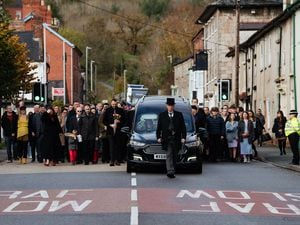 Funeral director Darren W Faragher leads the procession along the A483 in Llanymynech