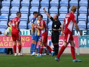 Tom Flanagan of Shrewsbury Town is shown a second yellow card and is sent off.