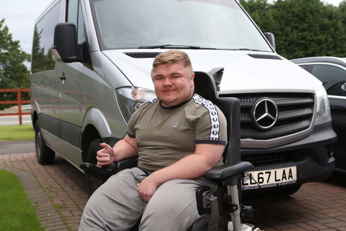 Luke outside his Telford home with the specially-adapted van he's been using to learn to drive