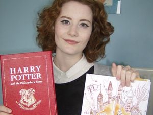 Chloe Esslemont, aged 16, holding her book prize and competition entry