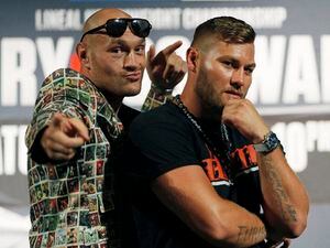 Tyson Fury, left, of England, and Tom Schwarz, of Germany, pose during a news conference for their upcoming fight