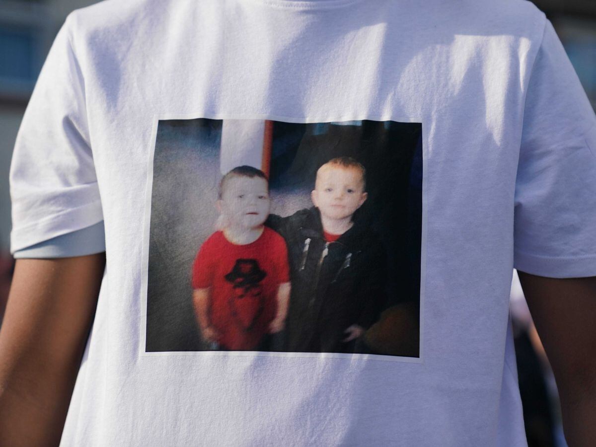 A person wearing a t shirt with a picture of Harvey Evans, 15 (left) and Kyrees Sullivan, 16, on it, during a vigil for the victims of a road traffic collision on Snowden Road in Ely, Cardiff, on Monday