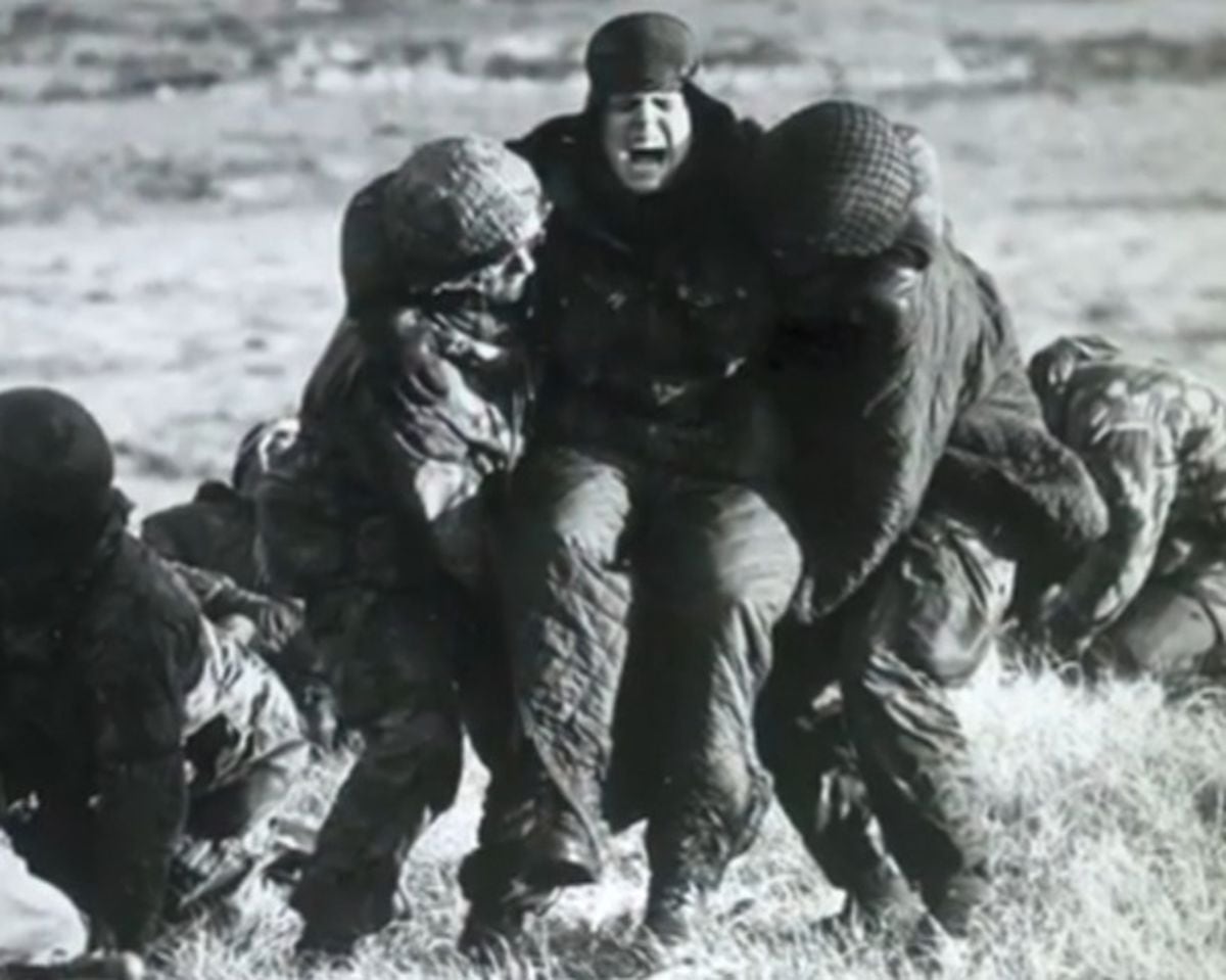 Nigel's comrade Pte Chris Dexter being carried after being hit by shrapnel on Mount Longdon