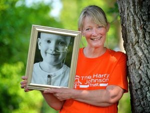 Sally Johnson BEM with a picture of her son Harry