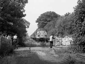 Opening the gates at Trench Crossing railway station during the Branch Line Society's "The Donnington Farewell" rail tour on July 6, 1991.