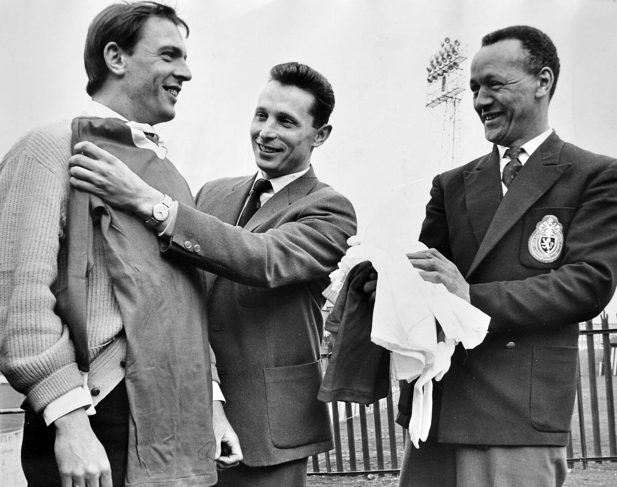 A new kit to mark a new era. Wellington Town centre forward Jack Bentley is measured for size by player-manager Grenville Hair, with Charlie Williams, chairman of the supporters' club, looking on. The supporters' club presented a new kit of red shirts with white edging, white shorts and red and white stockings, to be worn for the first time in the inaugural floodlit game against Leeds in March 1965.