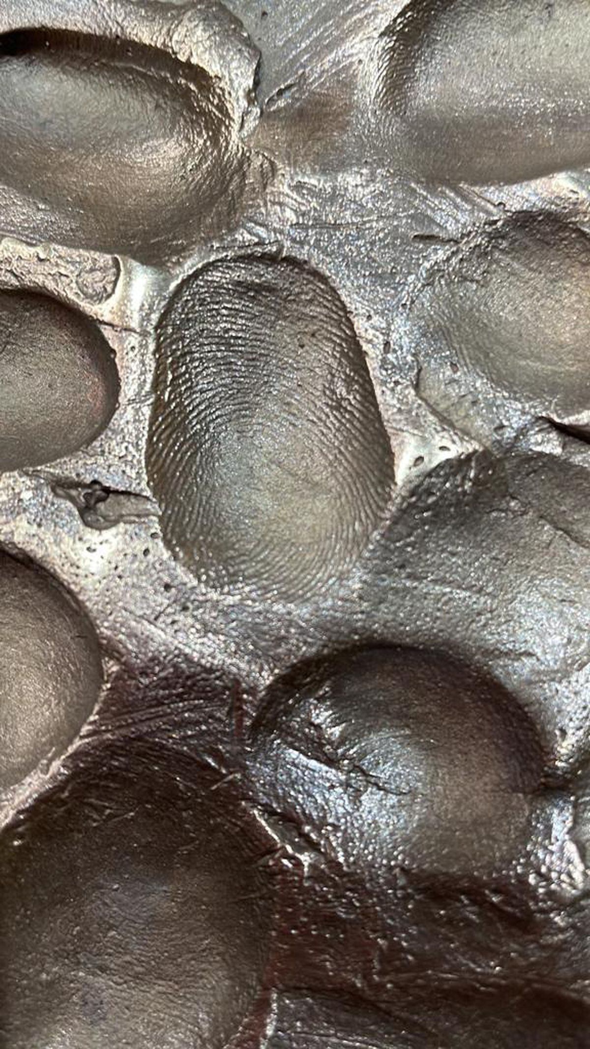 A close-up of the finger prints that feature as part of the sculpture