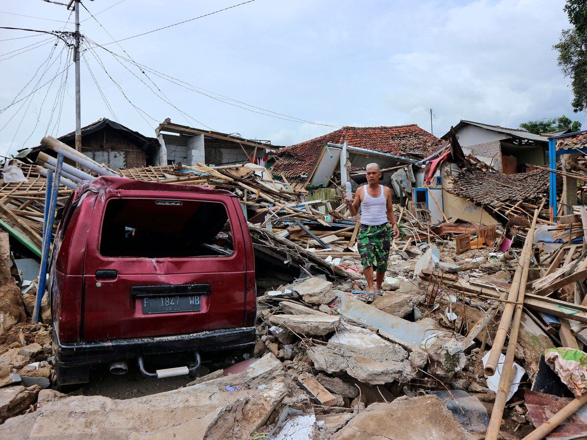 A man walks on the rubble of houses in a neighbourhood heavily affected by Monday’s earthquake in Cianjur, West Java, Indonesia