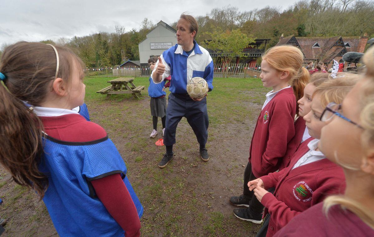 Children from Christ Church CE School in Shrewsbury warm up before a kick-about with with Simon Tisdale from the Shrewsbury FC Foundation