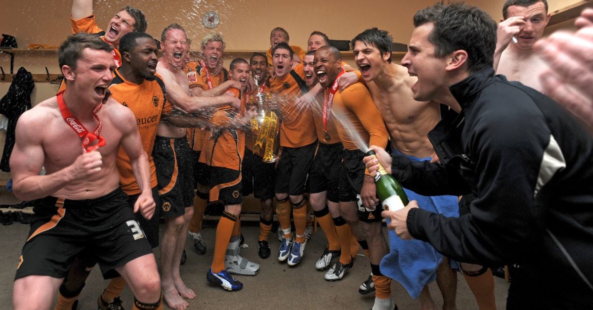 Players of Wolverhampton Wanderers celebrate with the trophy after winning the Coca Cola Football League Championship in the dressing room.