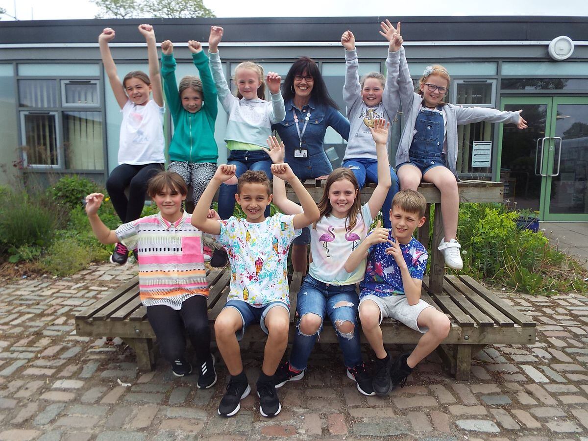 Head Sue Lovecy celebrates with some year 5 children. They school was holding a charity, non uniform day